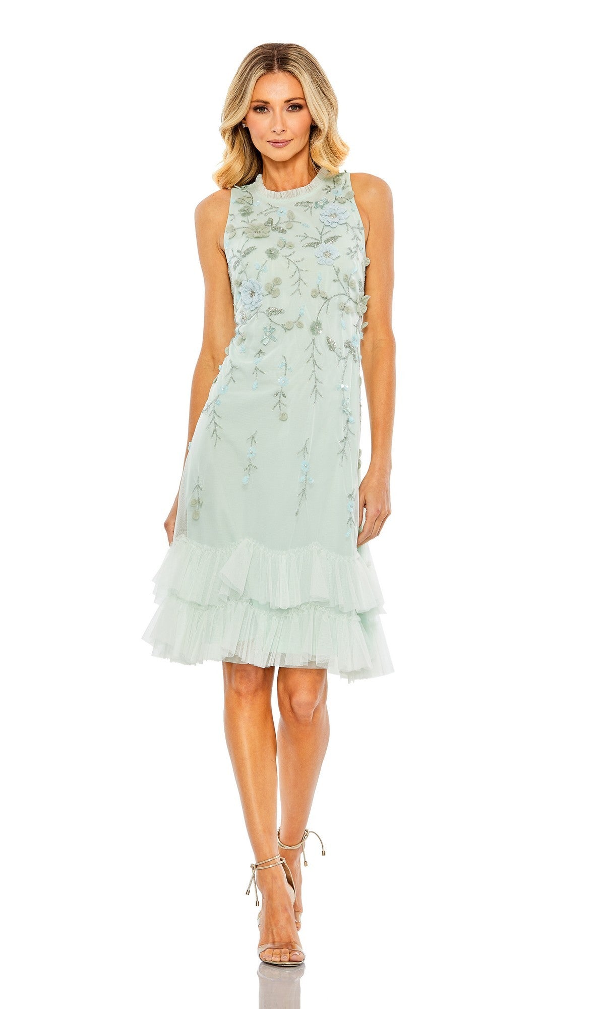 A woman wears the Mac Duggal 9188 Midi Wedding Guest Dress in seafoam with floral embellishments and ruffled tulle hem, paired with strappy heels—an elegant wedding guest look.